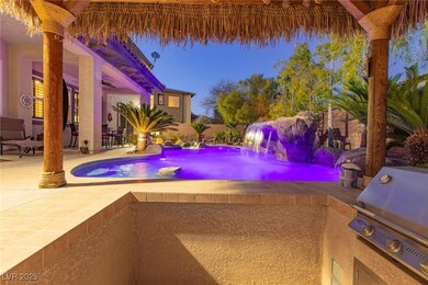 Pool with a patio, an outdoor kitchen, and a grill