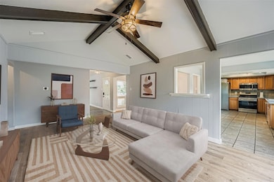 Living room with light wood-style flooring, a cei