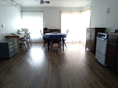 Dining space with ceiling fan and dark hardwood / 
