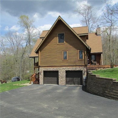 Side view of home. All stone surround on garage do
