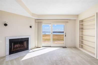Living room with wood burning fireplace and water