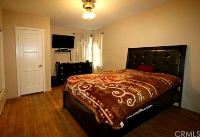 Master bedroom with original hardwood floors and p