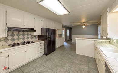 Spacious kitchen with tile floors, gas cooktop, se