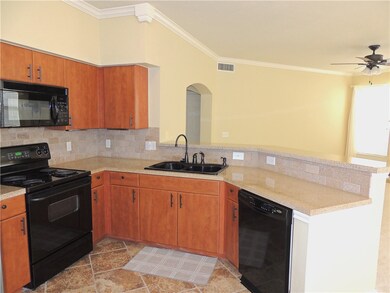 Kitchen has plenty of space with a high bar for ea