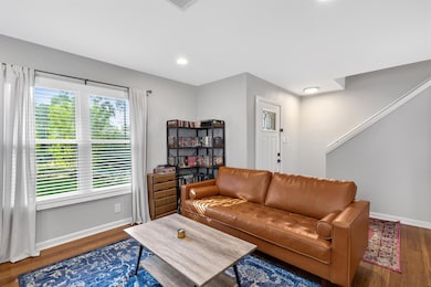 Living area with baseboards, wood finished floors