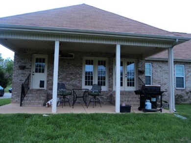 Back Covered Porch 27x13.  You will enjoy this area while looking out to the beautiful pond on the property.  There are two entrances one into the Breakfast Room and one into the tiled  Laundry/Mud Room 