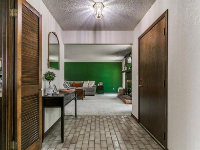 Corridor featuring a textured ceiling