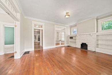 Beautiful Hardwood Floors, Decorative Fireplace, and Built-ins in this Large Living Room.