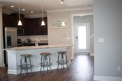 Beautiful modern kitchen with dark cabinetry and t