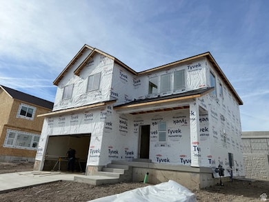 Property in mid-construction with an attached garage, concrete driveway, and a porch