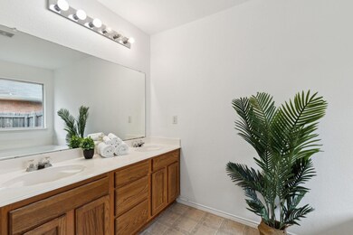 Bathroom with tile patterned flooring, a tub to re