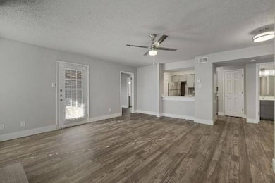Unfurnished living room with dark wood-type floori