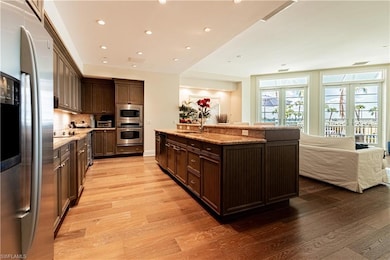 Kitchen featuring light wood-style flooring, dark 