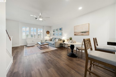 Living room featuring ceiling fan, wood finished floors, stairway, and recessed lighting
