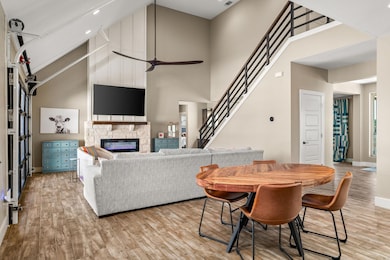 Dining space with a high ceiling, stairway, light