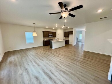 Unfurnished living room featuring recessed lighting, healthy amount of natural light, wood finished floors, and ceiling fan