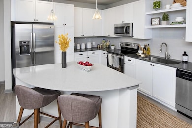Kitchen featuring backsplash, stainless steel appl
