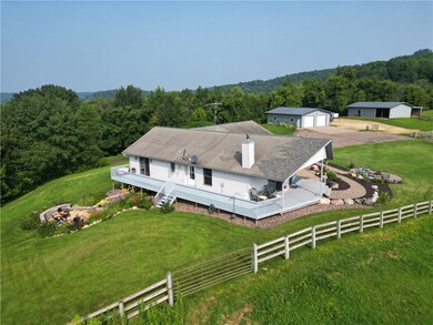 Property is beautifully landscaped and includes a wrap around deck, private back patio and incredible front fire pit area affording the most special country views!