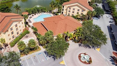 Bird's eye view of a pool area and a nearby body of water