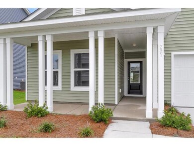 Entrance to property featuring a garage and covere