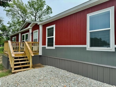 View of side of home featuring a wooden deck