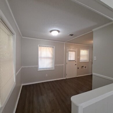 Unfurnished room with crown molding, a textured ce