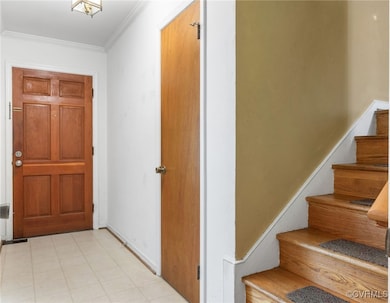 Entryway with stairs and crown molding
