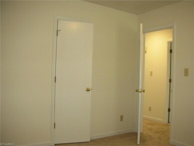 Bedroom 2: Features include carpet flooring to help keep you warm and cozy, a window for natural lighting and blinds for privacy and fresh paint. Here we can see the closet door in the middle and to the right side is the entry door.