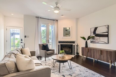 Living area with dark wood-style floors, a firepl