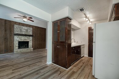 Kitchen with white appliances, wood finished floo