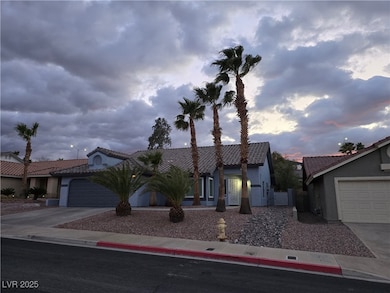 View of front of home with stucco siding, an attac