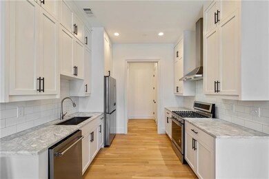 Kitchen featuring visible vents, baseboards, wall 