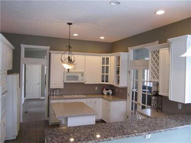 Kitchen. Gorgeous kitchen with tons of custom cabinetry, center island, granite breakfast bar, and all appliances included.