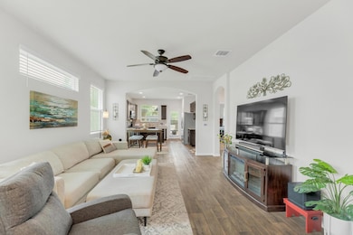 Living area featuring arched walkways, a ceiling 