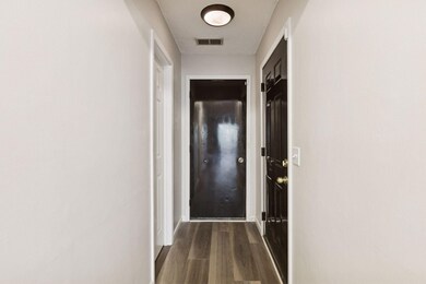 Functional hallway offering direct access to the attached garage and a spacious walk-in closet.