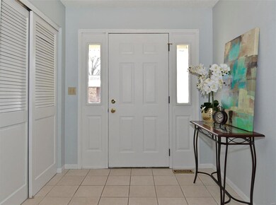 Formal entry way with tile and closet.