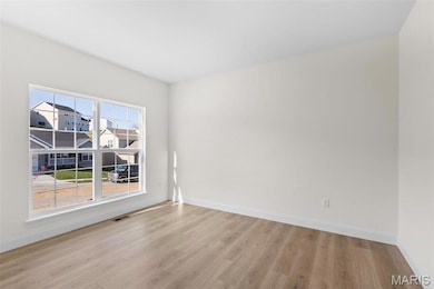 Spare room featuring light wood-type flooring