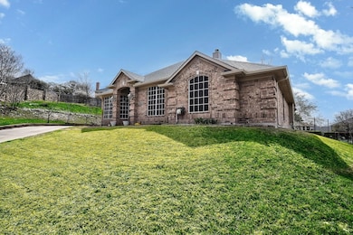 View of front of house featuring fence, roof with 