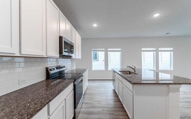 Kitchen with stainless steel appliances, backspla