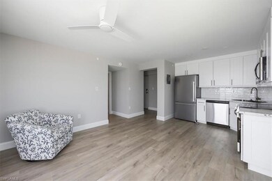 Kitchen featuring sink, white cabinetry, light har