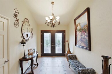 Welcoming etched glass double doors open wide to e