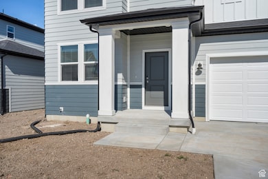 Doorway to property with a garage