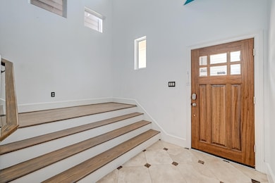 Elegant entryway with stylish tile flooring and ab