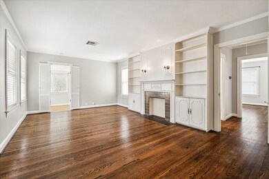 Living room is full of character from the antique tiles and mantle detailing that surround the fireplace, to the framed bookshelves/storage with vintage wood trims. Hardwood floors. The abundance of natural light is evident in every room!