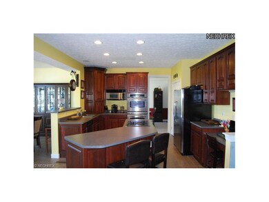Kitchen features double ovens and large island.
