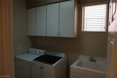 Cabinets, sink. Entry from the 3 car garage.
