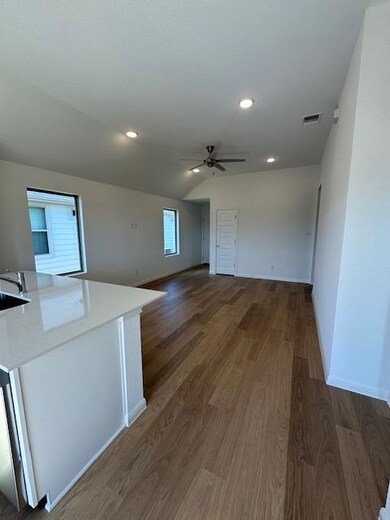 Unfurnished living room with a ceiling fan, wood 