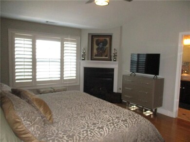 Bedroom featuring baseboards and wood finished flo
