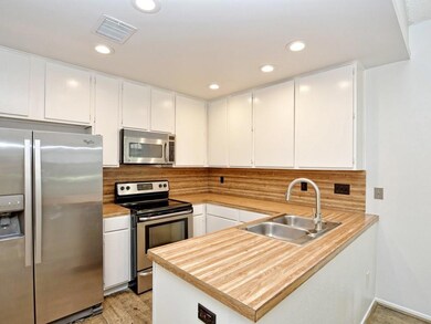 Kitchen with tasteful backsplash, appliances with