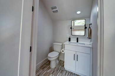 Bathroom with vanity, baseboards, tile patterned 